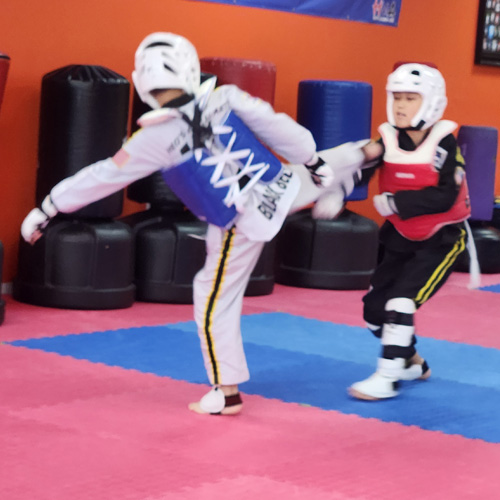 Two kids are sparring